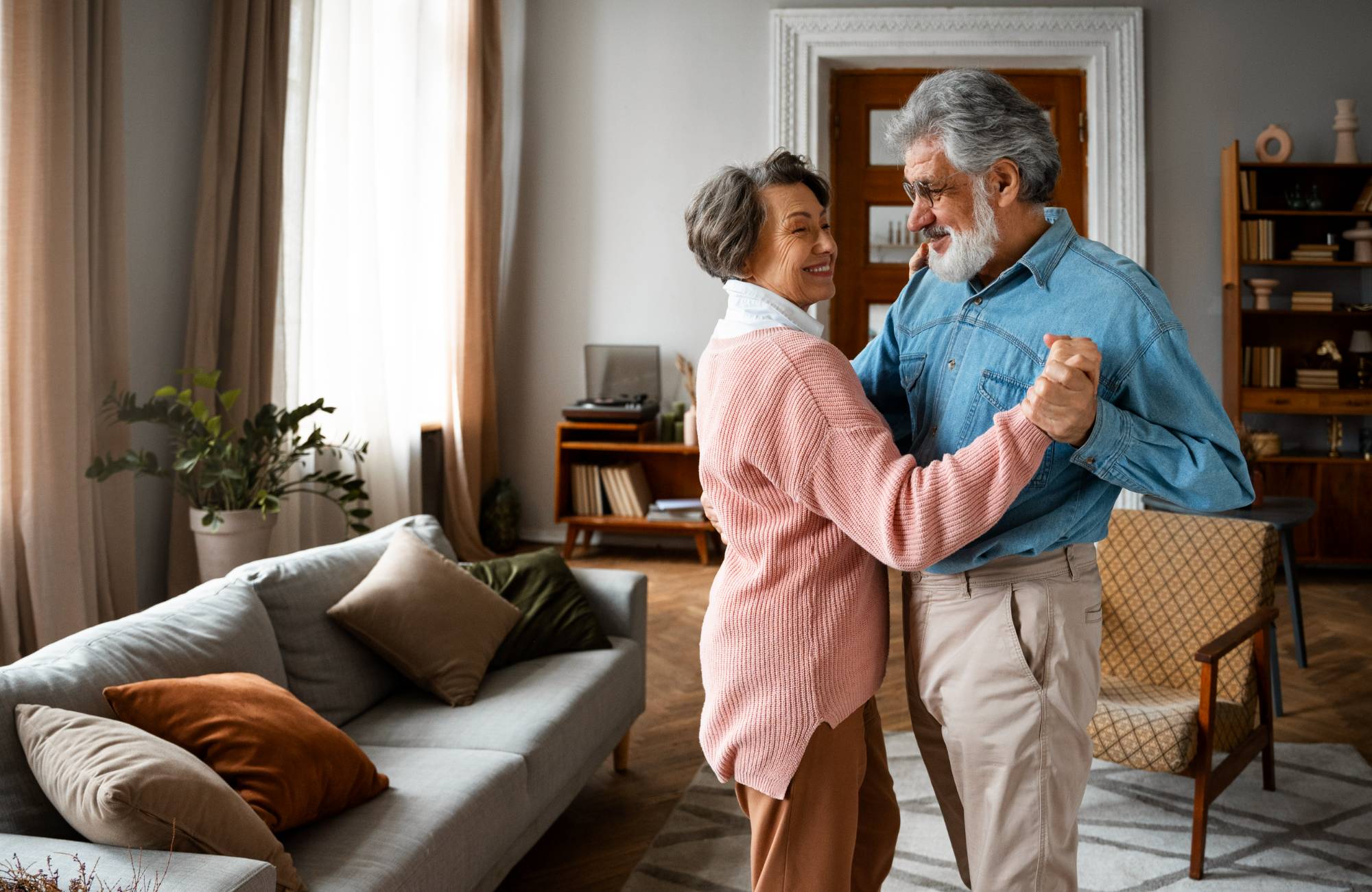 happy senior couple dancing after move help